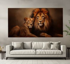 two lions sitting next to each other on a wall above a couch in a living room