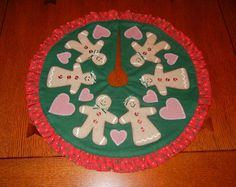 a green and red table cloth with gingerbreads on it