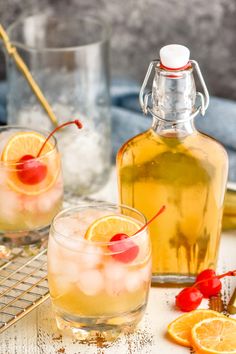 two glasses filled with lemonade and cherries