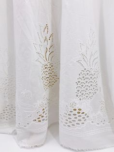 two white curtains with pineapples on them