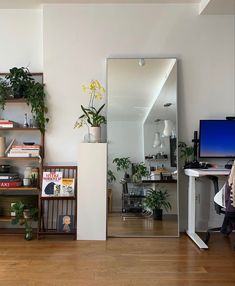 a living room filled with furniture and a flat screen tv sitting on top of a wooden floor