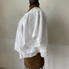 Hello and welcome to the Textile Trunk! Please follow us on Instagram , our user name is textiletrunk A fabulous rare find! Lace trimmed, GORGEOUS! his textile is a choir blouse dating from c 1900 or late 1800's. Made of crispy white cotton , This shirt was a Choir blouse and has lovely mends! ~ it was used and loved. There are some small stains on the back of one of the sleeves near the mends that would probably come out with some spot bleach work! I LOVE this blouse!! ( Eshirt 11094) MEASUREME Victorian Lace Trim Top For Daywear, Daywear Lace Top With Lace Cuffs, Lace Top With Lace Cuffs For Daywear, Vintage Cotton Blouse With Lace Cuffs, Victorian Cotton Tops With Lace Trim, Victorian Cotton Top With Lace Trim, Victorian Cotton Tops For Summer, Peasant Tops With Lace Trim For Daywear, Cotton Lace Patchwork Top For Daywear