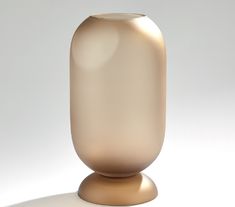 a glass vase sitting on top of a white table