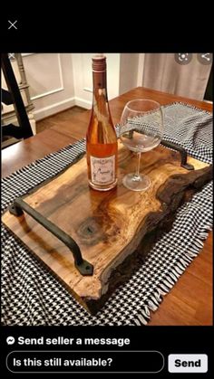 a bottle of wine sitting on top of a wooden tray