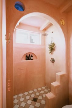 a bathroom with pink walls and tiled flooring