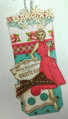 a card with a woman in a red dress and some buttons on the back of it