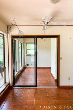 an empty room with tile floors and sliding glass doors