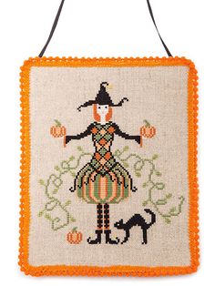 an orange and white cross stitched bag with a woman in a dress on it