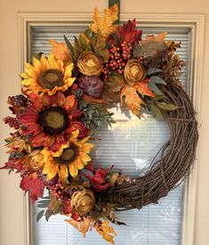 a wreath with sunflowers and autumn leaves