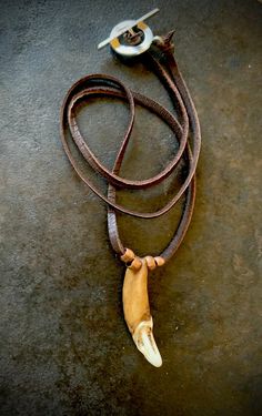 Wolf tooth Necklace on a dark brown deerskin leather cord with copper beads. This necklace is made with a wolf tooth that is approximately 1 and 1/2" long. Each piece of jewelry I make is made with specific intention and symbolism. Indigenous peoples recognize the wolf as a guide and teacher and this necklace was made to honor all our teachers. I also used 4 copper beads in this necklace. Copper has been used as a healing mineral since ancient times. When copper is worn next to the body it is absorbed and is known to help decrease inflammation such as arthritis and carpal tunnel. Copper is also a conductor of energy, intensifying the properties of stones and crystals around it. The cord on this necklace is dark brown deerskin leather. Deerskin leather is very soft and durable. The deerskin Teeth Necklace, Wolf Tooth Necklace, Wolf Tooth, Wolf Teeth, Wolf Necklace, Wolf Jewelry, Tooth Necklace, Spirit Guide, Wolf Spirit