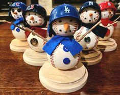 baseball themed snowmen are lined up on a table