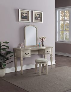 a white dressing table with mirror and stool