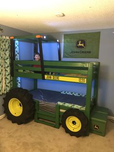 there is a bunk bed made to look like a tractor with two large tires on it