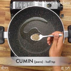 a person is stirring some food in a pan on the stove top with a spoon