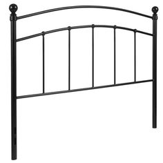 a black metal headboard with four posts