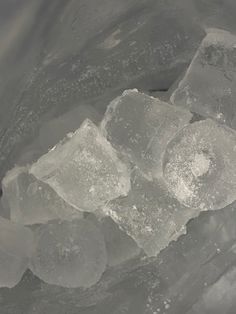 ice cubes are sitting on top of some water