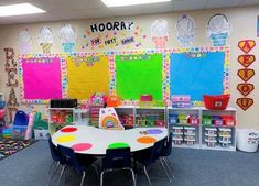 an empty classroom with colorful walls and lots of toys on the floor in front of it