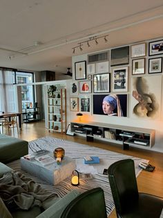 a living room filled with furniture and pictures on the wall