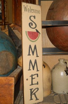 a welcome sign sitting on top of a shelf