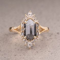 a fancy ring with an oval cut diamond and baguettes set in yellow gold