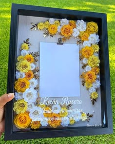 a person holding up a frame made out of paper flowers with the words kawai rosena written on it