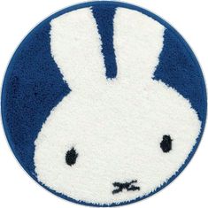 a blue and white rug with an image of a rabbit's head