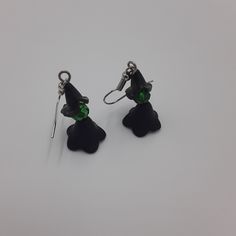 These witch earrings are a must-have accessory for any lover of the dark and magical. Handmade with 4mm black beaded pieces, green bead head, and silver ear-wire, these earrings are a simple yet stylish addition to any Halloween outfit. Whether you're attending a party or just looking to add some spooky flair to your everyday look, these earrings are a perfect choice. Don't miss out on this must-have accessory for the season of the witch! 🪄 Free shipping on all orders $35 or above 🪄 Each piece Black Single Earring For Halloween, Witchy Drop Earrings, Black Beaded Dangle Earrings For Halloween, Black Dangle Beaded Earrings For Halloween, Green Halloween Party Earrings, Witchy Black Nickel-free Earrings, Green Halloween Dangle Earrings, The Season Of The Witch, Earrings Gothic