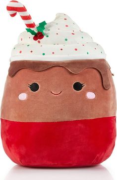 a large stuffed toy with a frosted cupcake on it's head and a candy cane sticking out of its mouth