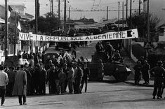 an old black and white photo of people standing in front of a car with a banner that reads vive i a repubit du algemiene