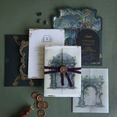 the wedding stationery is laid out on top of each other, including an envelope with a ribbon