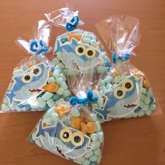 some cookies are wrapped in plastic and have googly eyes on them as well as blue candies