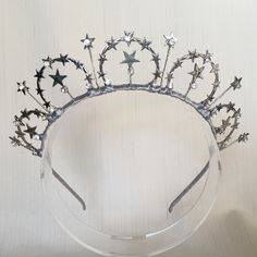 Handmade and uniquely designed headpieces from the Star Collection. Drawing inspiration from all things celestial, a whimsical and striking galactic trend perfect for a wide range of occasions. A boho tiara of rustic stars with a little touch of rhinestone bling hand wired onto a satin wrapped band. To shop more items from the Star Collection: https://www.etsy.com/au/shop/MerineDesigns?ref=simple-shop-header-name&listing_id=711775814&section_id=26869808 Star Headpiece, Star Tiara, Boho Tiara, Collection Drawing, Star Silver, Star Headband, Hair Wreaths, Wedding Tiara, Bridal Headpieces