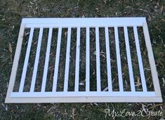 a white grate sitting in the grass