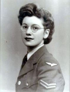 an old black and white photo of a woman in uniform