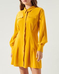 Embrace retro vibes in this utterly groovy long-sleeved mini dress. Boasting a button-front design and a flirtatiously flared godet skirt, it's a nod to 70s fashion. Pair it effortlessly with mid-calf boots to transport yourself back in time to the disco era or with a pair of strappy heels for a chic modern appeal. DETAILS Button front Pintuck detail Long sleeve Godet skirt Length: 34 1/2" Model is wearing XS MATERIAL Self: 100% Polyester To The Disco, Godet Skirt, Work Formal, Disco Era, Prom Party, Mid Calf Boots, Back In Time, Retro Vibe, 70s Fashion