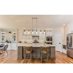 a large kitchen with an island in the middle