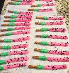 there are many pink and green toothbrushes on the counter top with sprinkles