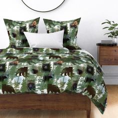 an image of a bed with bears in the woods printed on it and white pillows