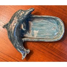 a dolphin figurine sitting on top of a wooden table