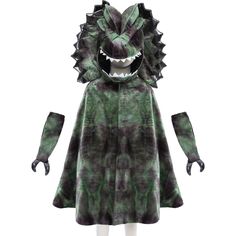 a green and black monster costume on a mannequin's head, with its mouth open