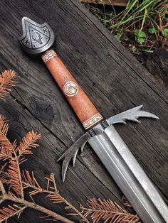 a knife with a wooden handle sitting on top of a table