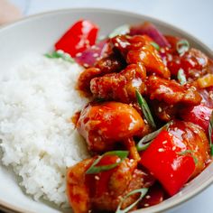 a white bowl filled with rice and meat