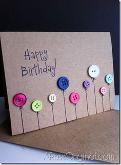 a birthday card with buttons attached to it