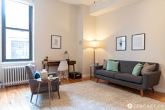 a living room filled with furniture next to a window and a radiator on the wall