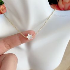 Tiny Mother of Pearl (Nacre) star necklace. The nacre has a high luster with white tones. Celestial jewelry is in at the moment. This is a lovely star necklace, it's a delight for the eyes! This dainty Mother of Pearl star, is made with a gold-plated chain. Perfect for everyday wear, this necklace looks great layered with other necklaces or by itself. When you put on a piece of jewelry, you probably focus on how it looks with your outfit or what it says about your style. Remember, in simplicity, White Star-shaped Jewelry With Clavicle Chain, Minimalist Gold Necklace With Star Of David, White Dainty Choker With Adjustable Chain, White Dainty Choker With Clavicle Chain, Dainty White Choker With Adjustable Chain, Dainty White Choker With Clavicle Chain, Dainty White Choker With Delicate Chain, Minimalist Star Of David Jewelry With Delicate Chain, Adjustable 14k Gold Filled Choker As Gift