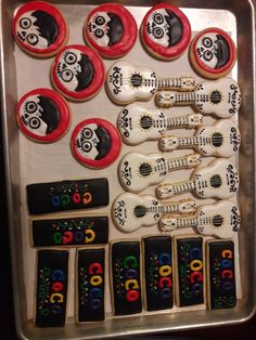 decorated cookies in the shape of guitars and skulls