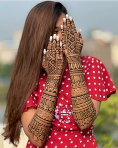 a woman with her hands covered in henna