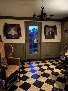 a living room with two chairs and a checkered floor in front of a door