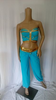 a female mannequin dressed in blue and gold with her hands on her hips