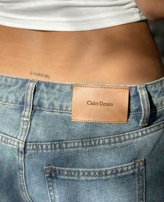 the back of a woman's stomach with a leather label on it that says olden denim